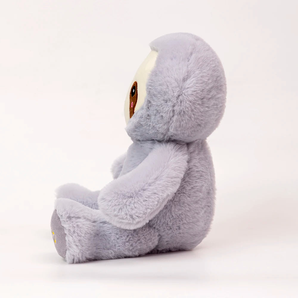 A soft gray sloth plush toy with large eyes sitting on a white background.