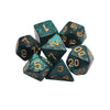 A set of seven polyhedral dice in dark green glass with gold numbering, used for tabletop role-playing games.