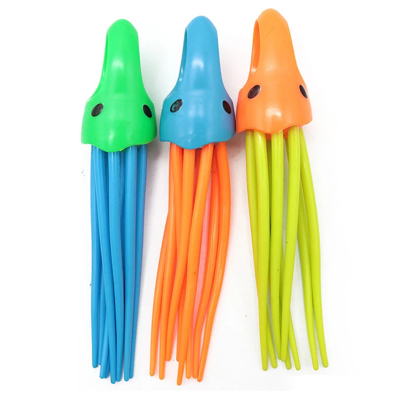 A set of three colorful dive toys shaped like fish, featuring green, blue, and orange bodies.