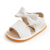 White baby summer sandals with a bowknot and soft anti-slip sole