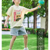 A young girl is playing with a green pull-string flying saucer launcher toy outdoors on the grass.