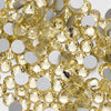 A close-up view of small, round, faceted yellow glass crystal flatback rhinestones.