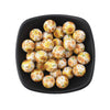 A black dish filled with small, round, printed silicone beads in leopard and daisy patterns.