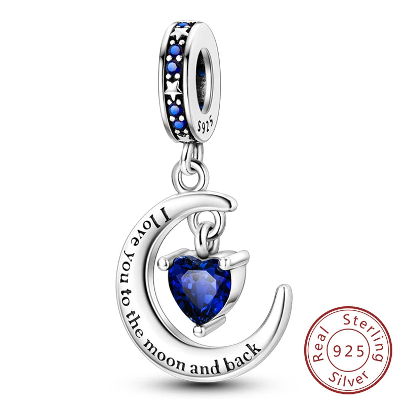 Sterling silver heart charm with a crescent moon design and blue stones for a bracelet.