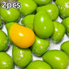 A collection of bright green and yellow color-changing mango squishy stress balls.