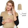 A woman is wearing a beige knitted fabric multi-functional baby carrier with a travel pouch attached.