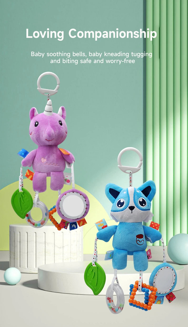 A purple unicorn plush toy with hanging rattles and teething toys displayed on a white surface.