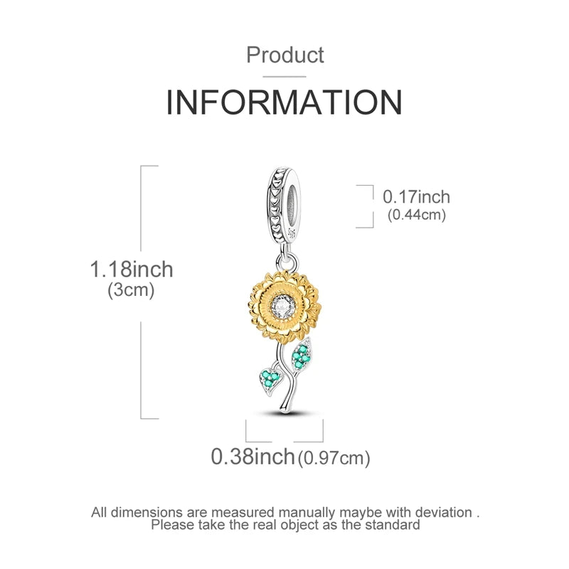 A gold-colored heart charm with a floral design and a small green leaf detail.