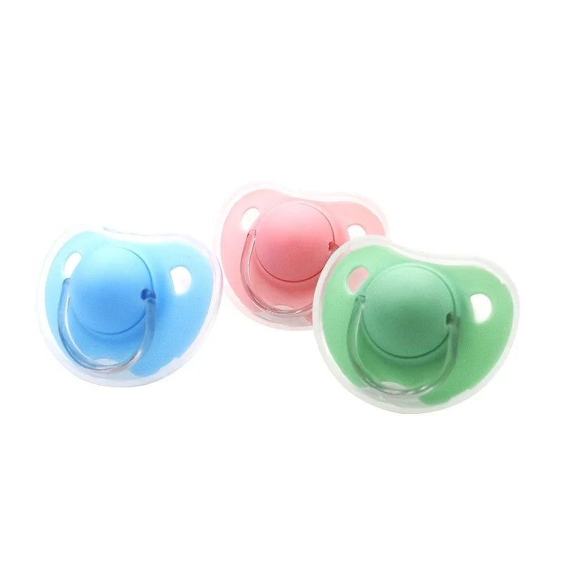 A set of two silicone pacifiers in pink and green colors with protective covers