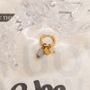 Gold hoop earrings featuring a blue stone and a gold crescent moon charm