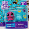A packaged set of Littlest Pet Shop figures featuring a pink and purple animal character.