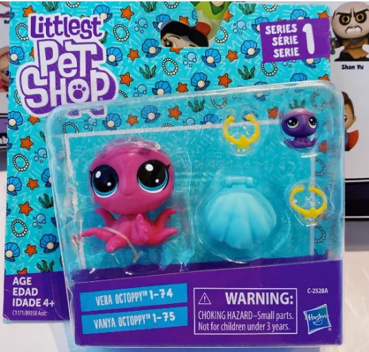 A packaged set of Littlest Pet Shop figures featuring a pink and purple animal character.