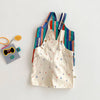A set of colorful striped kids overalls featuring a white fabric with a raindrop print.