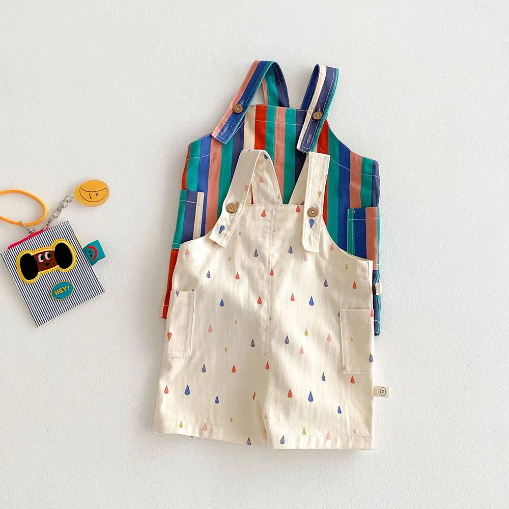 A set of colorful striped kids overalls featuring a white fabric with a raindrop print.
