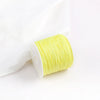A roll of bright yellow 0.8mm cotton nylon macrame cord for jewelry making and crafts.