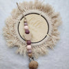 A personalized wooden baby pacifier clip featuring silicone beads attached to a natural fiber wreath.