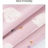 Pink cotton fabric with white floral print folded to show texture and softness.