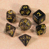 A collection of glitter polyhedral dice including a D4, D6, D8, D10, D12, and D20 set scattered on a light surface.