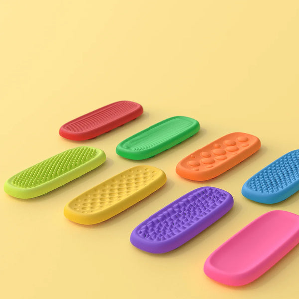 A collection of colorful silicone fidget strips in various shades including red, green, orange, yellow, purple, and pink, lai