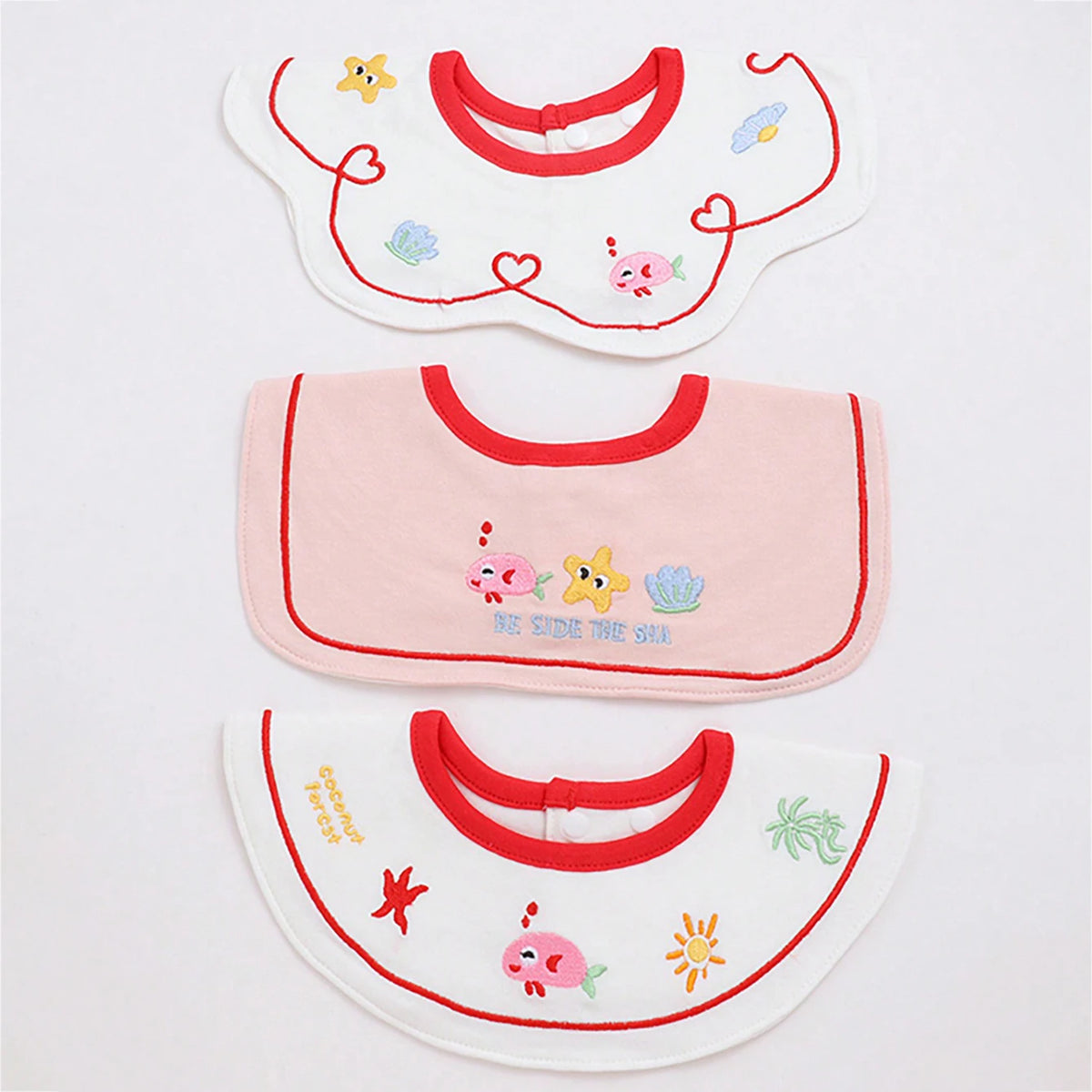 Set of three baby waterproof drool bibs featuring cute animal designs and a red trim.