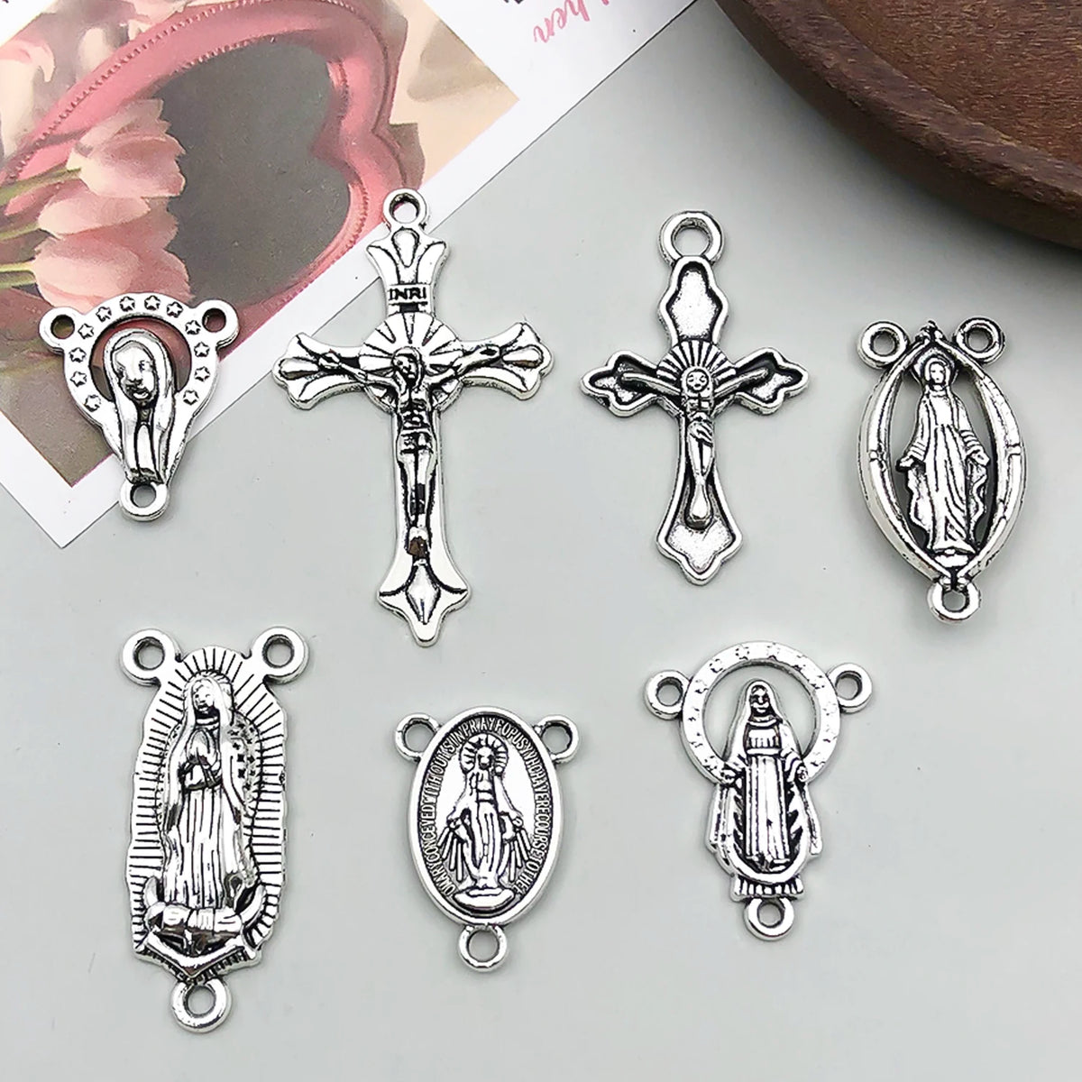 A collection of vintage antique silver cross charms and religious pendants for jewelry making.