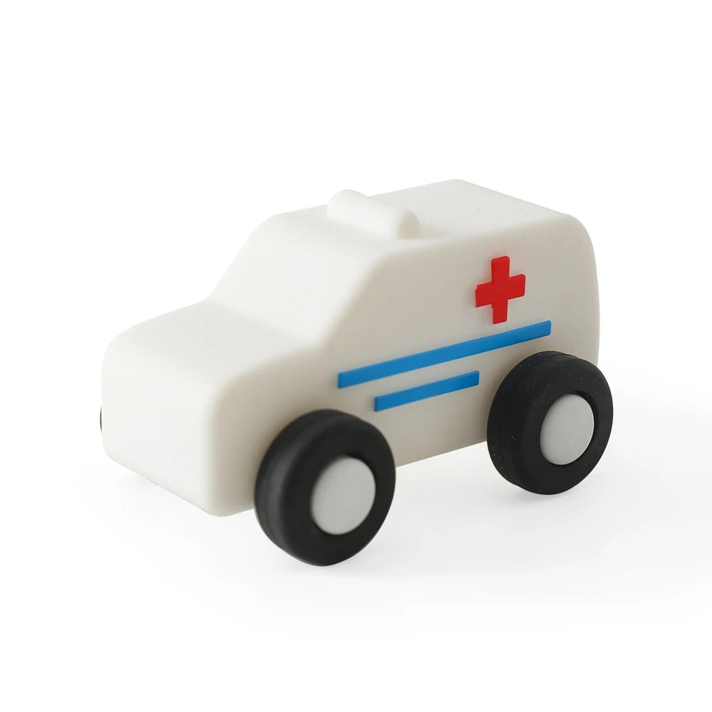 A white silicone toy car with blue stripes and a red cross on the side.