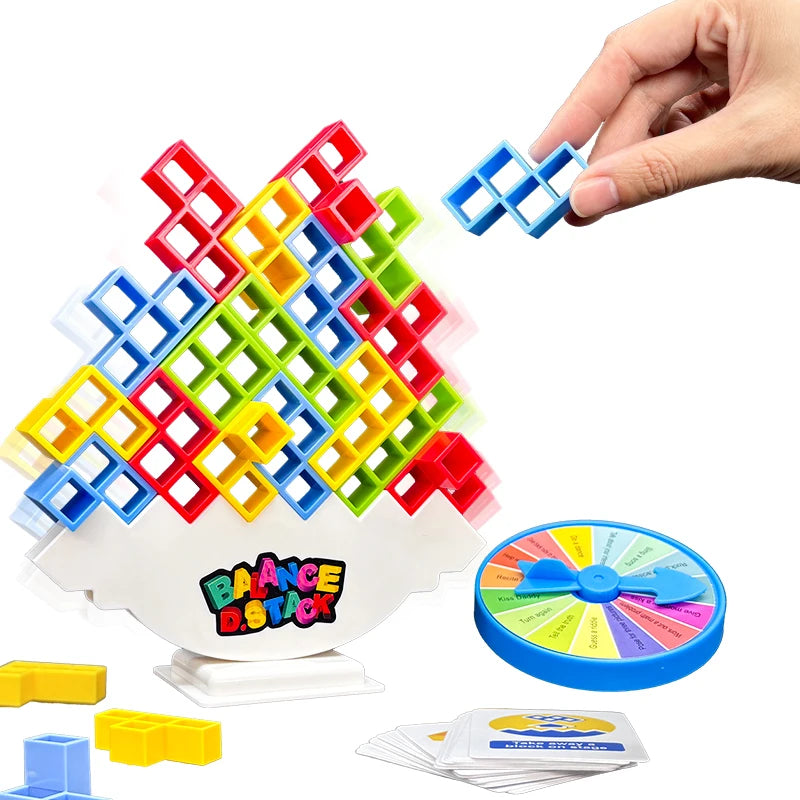 A hand is stacking colorful plastic blocks into a tower, demonstrating the Balance Stacking Tower game.