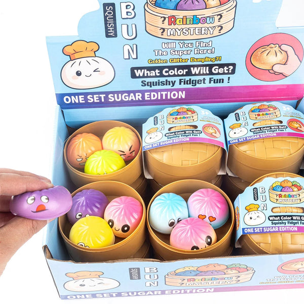 A box of colorful fidget dumpling toys in various shades including yellow, pink, and purple.