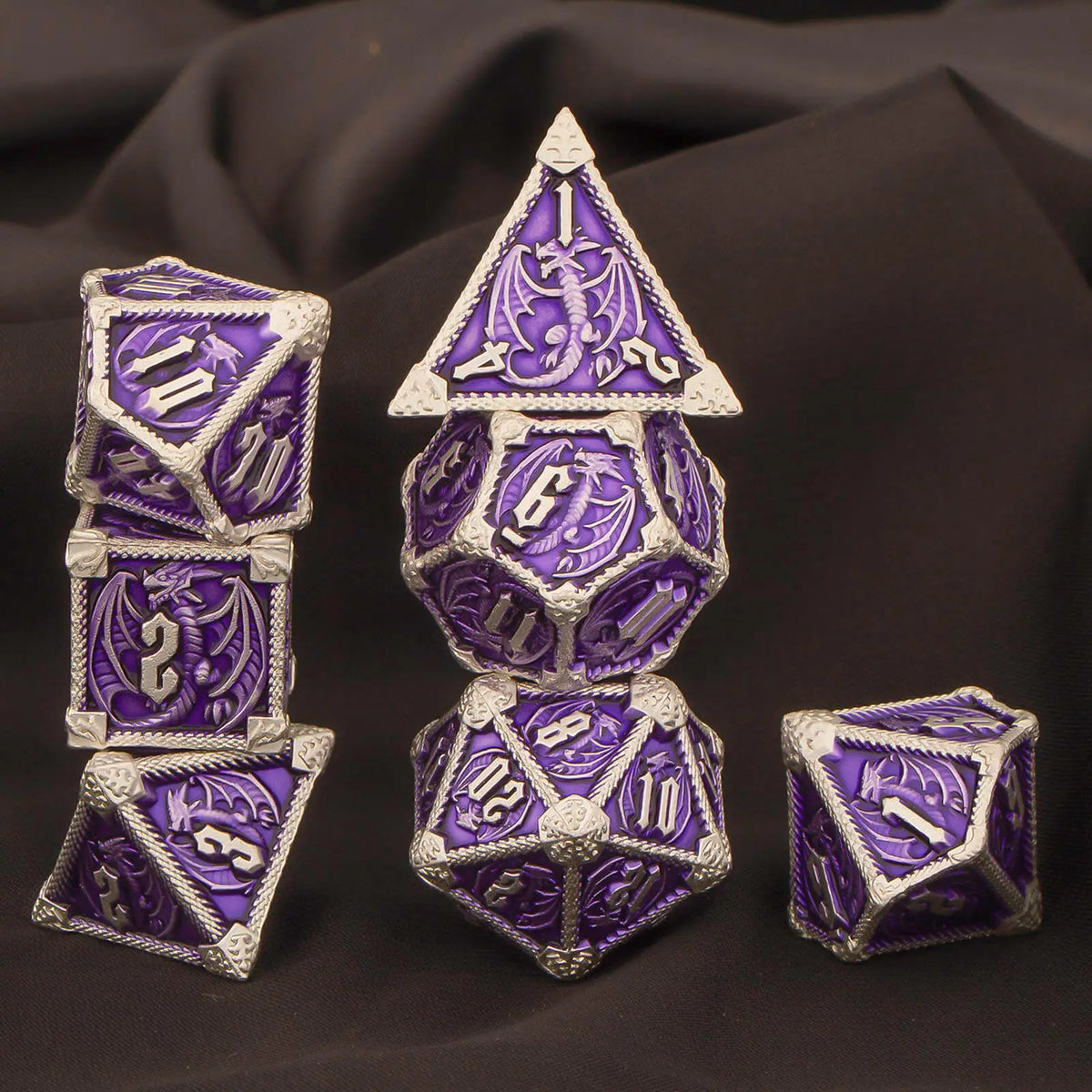 A set of seven polyhedral metal dice in purple and silver, including a d10, d12, d20, and others.