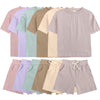 A collection of kids' summer tracksuit set including short sleeve tops and shorts in various pastel colors.