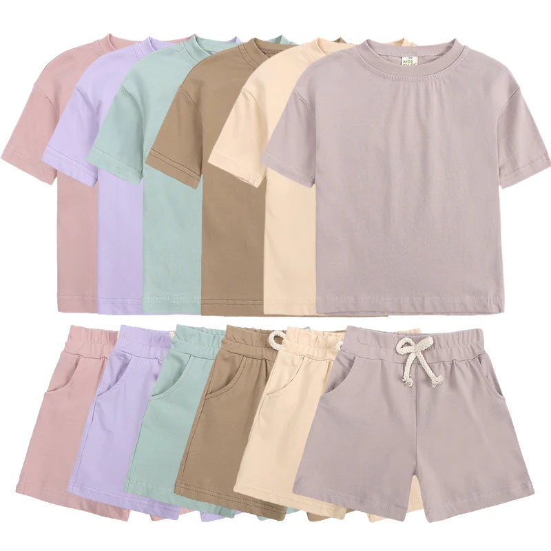 A collection of kids' summer tracksuit set including short sleeve tops and shorts in various pastel colors.