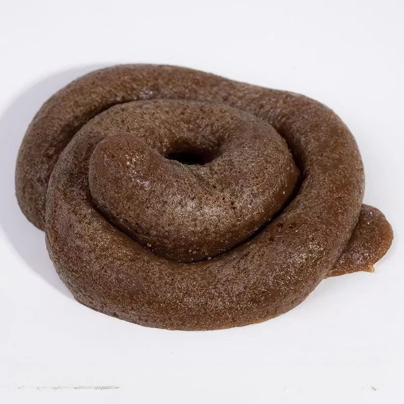 A realistic squishy prank toy shaped like soft fake poop, brown and textured.