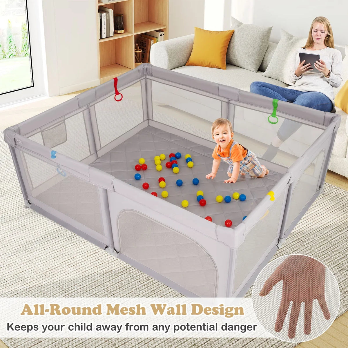 A large gray mesh baby playpen with a breathable design, shown in an indoor living room setting.