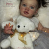 A lifelike reborn baby doll kit featuring a white teddy bear and painted vinyl parts.