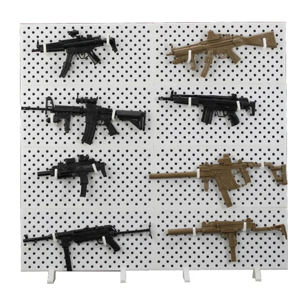 A display of various 1/6 scale military submachine gun model kits on a white grid background.