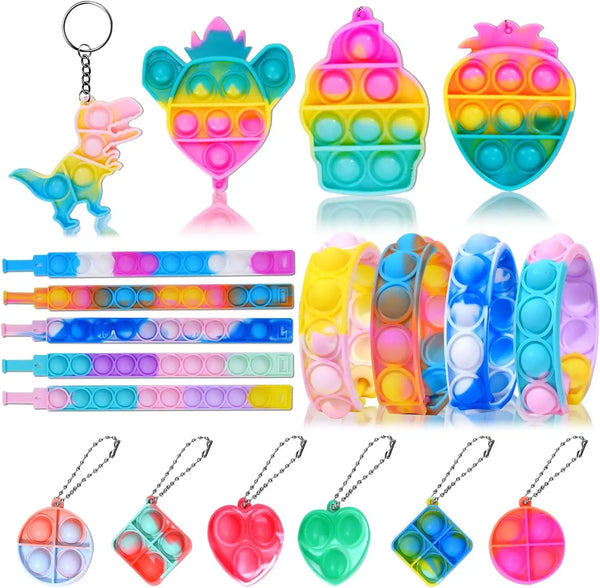 Assortment of colorful party favor toys including a dinosaur, a pineapple, and various silicone shapes.