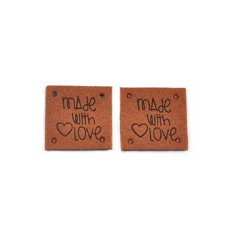 Two brown embossed leather labels with the text Made with Love stamped on them