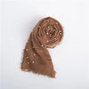 A rolled brown knit wrap with pearl detailing, used as a newborn photography knit wrap.