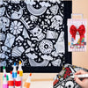 A DIY coloring blanket with 24 markers and a black and white patterned fabric is shown.