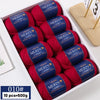 A box of red merino wool yarn balls for knitting sweaters, scarves, and hats