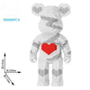A white knitted bear building block model with a red heart on its chest, shown in a frontal view.