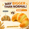 A giant croissant toy next to a normal size croissant, demonstrating the difference in size.