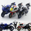 A collection of diecast Yamaha YZF-R1M scale motorcycle models in blue, white, and black colors.