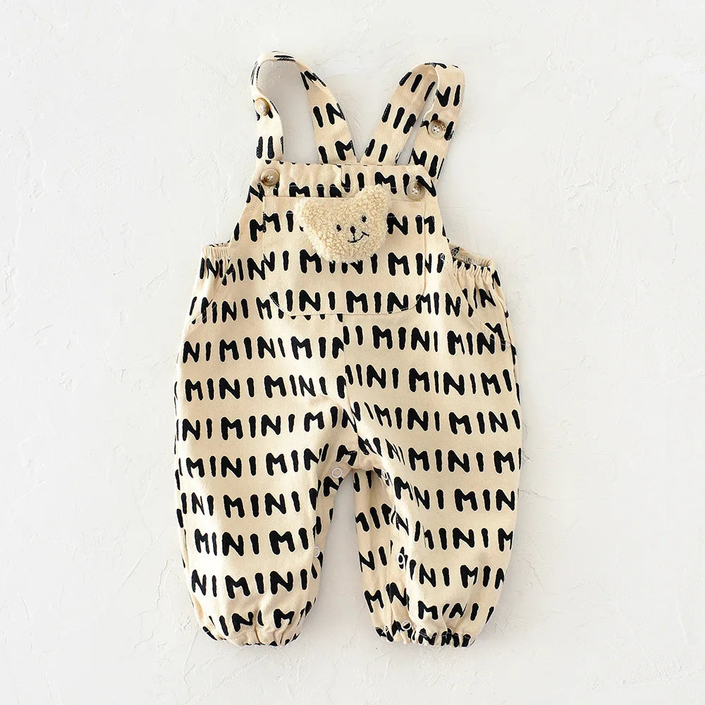 A beige striped baby romper featuring a bear decoration on the chest.