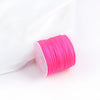 A pink spool of 0.8mm cotton nylon macrame cord for jewelry making and crafts.