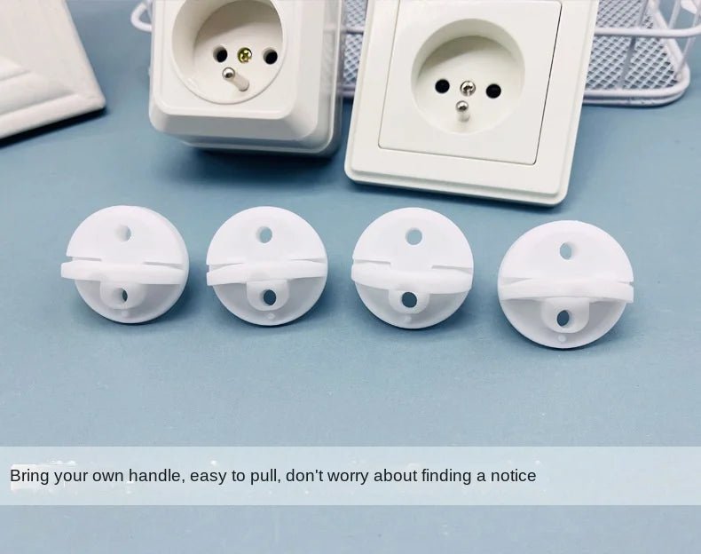 A set of white rotating socket safety covers for baby proofing, shown next to an electrical outlet.