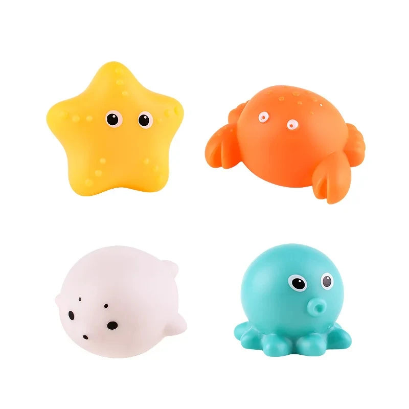 Three glow-in-the-dark animal washing water toys: a yellow star, an orange fish, and a blue blob.