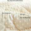 Close-up of a white, three-dimensional bean velvet massage blanket with soft touch and fine fur texture.