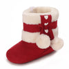 A pair of red and white faux fur baby winter boots with a bow detail.