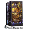 A dark wooden box containing a detailed pirate ship book nook model with an included music box.